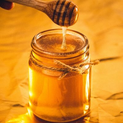 Jar of pure raw honey representing honey in Pakistan